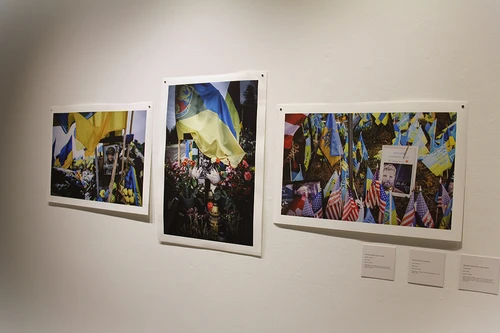 Three of Carillet’s photos titled “Ukrainian Soldier’s Grave in Kharkiv,” “Soldier’s Grave in Lviv, Ukraine,” and “Memorial to Pete Reed in Kyiv, Ukraine” are part of the featured exhibit.